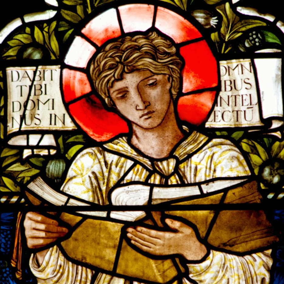 Stained glass window of St Timothy reading a scroll